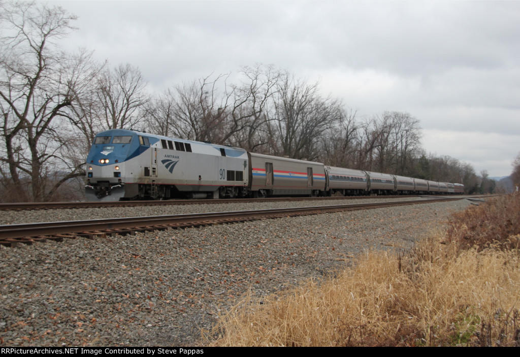 Amtrak 90 leads a train west with three private railcars in tow